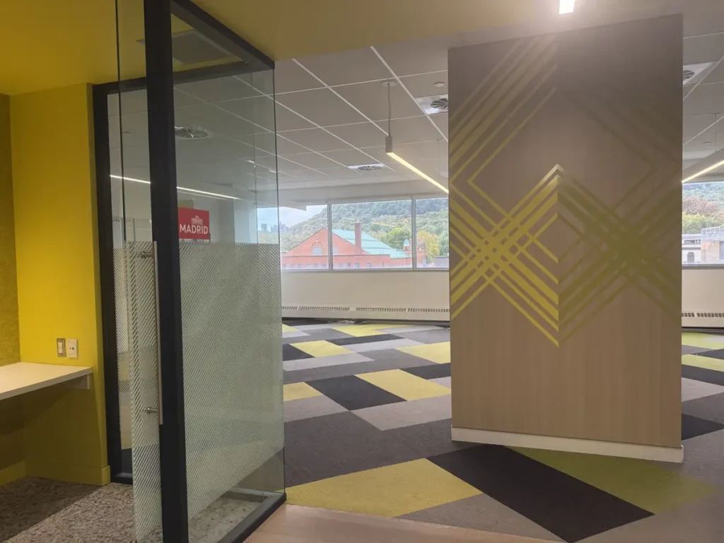 Glass-walled meeting room and open-concept space with a view of Mount Royal – 4200 Saint-Laurent Boulevard